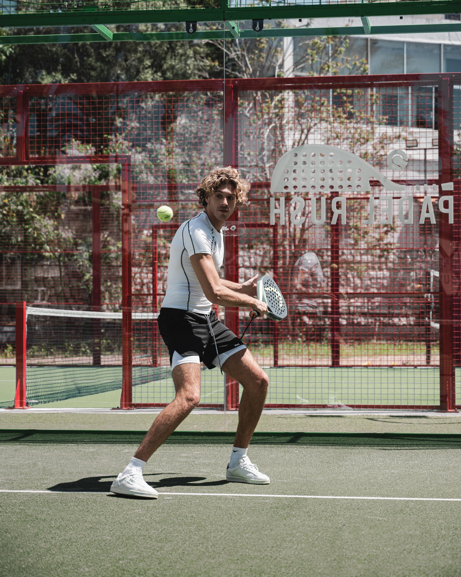 men wearing padel tee and shorts and playing padel on padel court